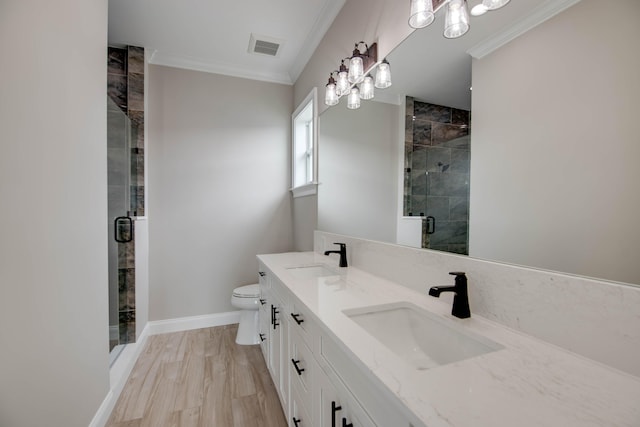 23066 Tarpon Ln, Cudjoe, FL 33042 - full bathroom featuring a chandelier, a stall shower, crown molding, double vanity, and toilet