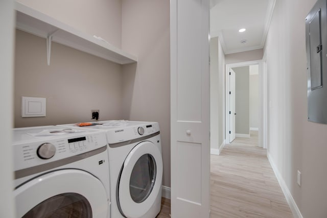 23066 Tarpon Ln, Cudjoe, FL 33042 - laundry room with washing machine and clothes dryer, ornamental molding, light wood-type flooring, and baseboards