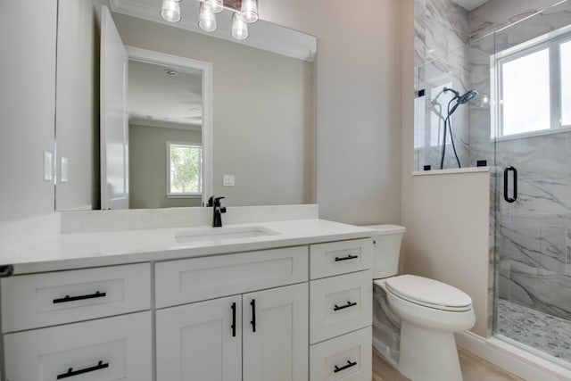 23066 Tarpon Ln, Cudjoe, FL 33042 - bathroom featuring a marble finish shower, ornamental molding, toilet, vanity, and wood finished floors
