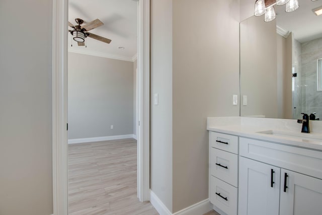 23066 Tarpon Ln, Cudjoe, FL 33042 - bathroom featuring ornamental molding, a shower stall, ceiling fan, vanity, and baseboards