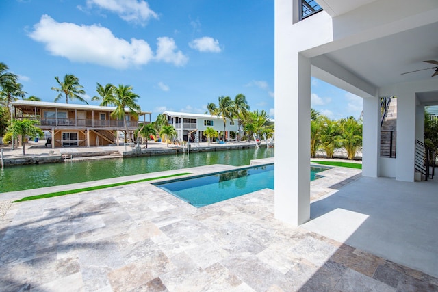23066 Tarpon Ln, Cudjoe, FL 33042 - outdoor pool with stairs, a ceiling fan, a water view, and a patio area