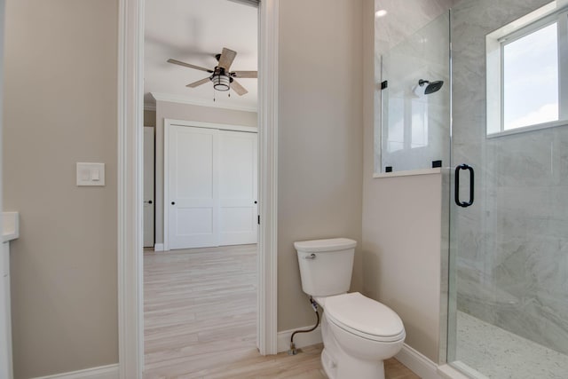 23066 Tarpon Ln, Cudjoe, FL 33042 - full bathroom with a stall shower, ornamental molding, ceiling fan, baseboards, and toilet