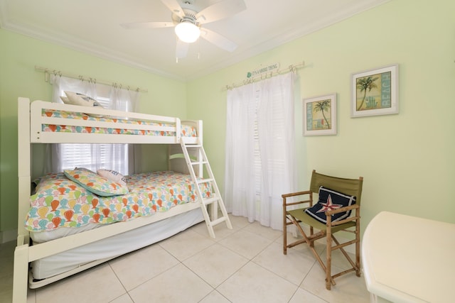 bedroom with tile patterned flooring, ornamental molding, and ceiling fan