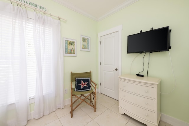 living area with ornamental molding, plenty of natural light, and light tile patterned floors