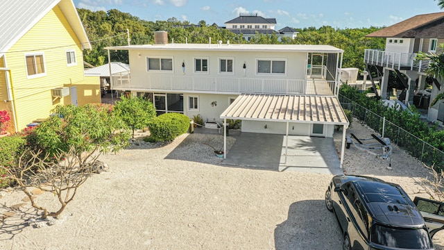 back of house featuring a wall mounted air conditioner, stucco siding, cooling unit, and a chimney