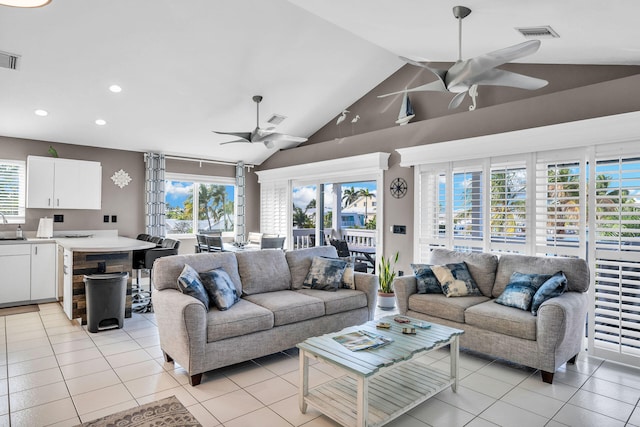 918 W Ocean Dr, Key Colony, FL 33051 - living room featuring a ceiling fan, lofted ceiling, light tile patterned flooring, plenty of natural light, and recessed lighting