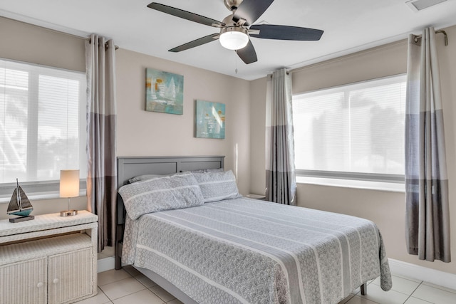 918 W Ocean Dr, Key Colony, FL 33051 - bedroom featuring light tile patterned floors, ceiling fan, and baseboards