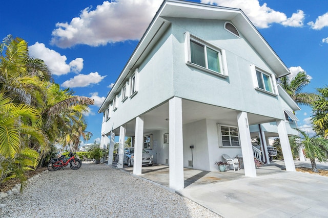 918 W Ocean Dr, Key Colony, FL 33051 - view of front of property featuring a carport, concrete driveway, and stucco siding