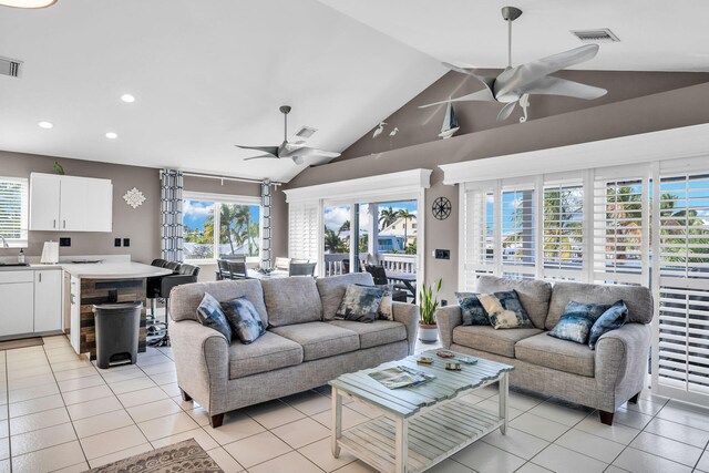 918 W Ocean Dr, Key Colony, FL 33051 - living room featuring a ceiling fan, lofted ceiling, light tile patterned flooring, plenty of natural light, and recessed lighting