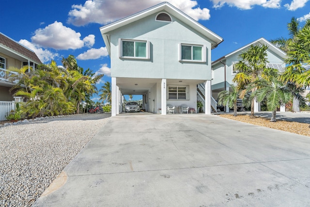 918 W Ocean Dr, Key Colony, FL 33051 - beach home with a carport, stairs, driveway, and stucco siding