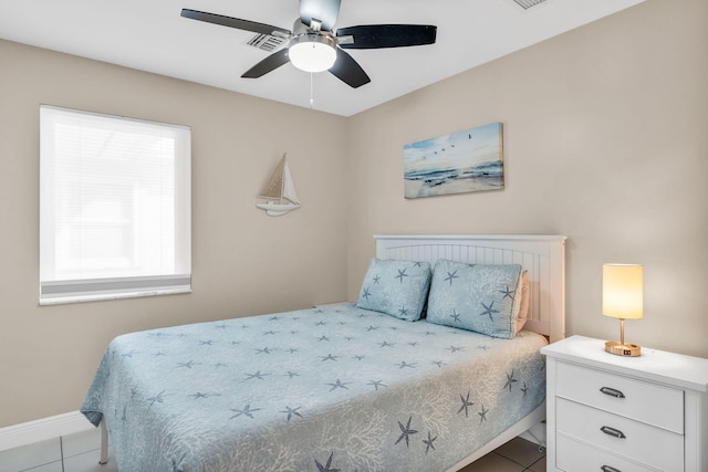 918 W Ocean Dr, Key Colony, FL 33051 - bedroom with tile patterned flooring, a ceiling fan, and baseboards
