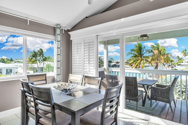 918 W Ocean Dr, Key Colony, FL 33051 - dining area with lofted ceiling, light tile patterned flooring, and healthy amount of natural light