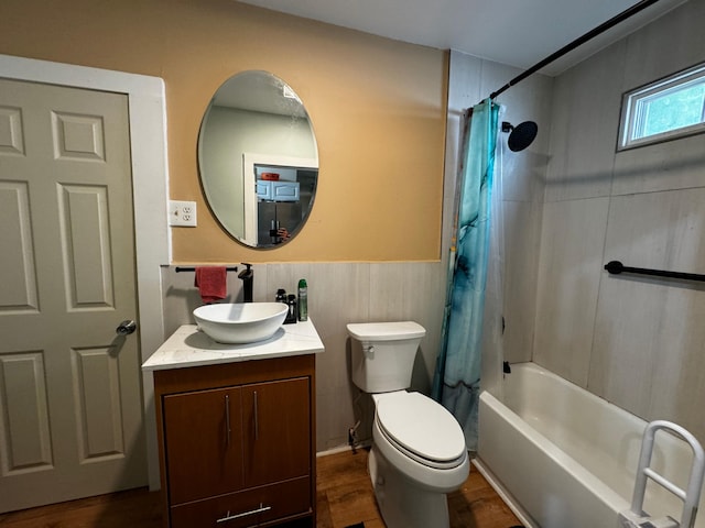 full bathroom featuring hardwood / wood-style flooring, vanity, shower / tub combo, and toilet