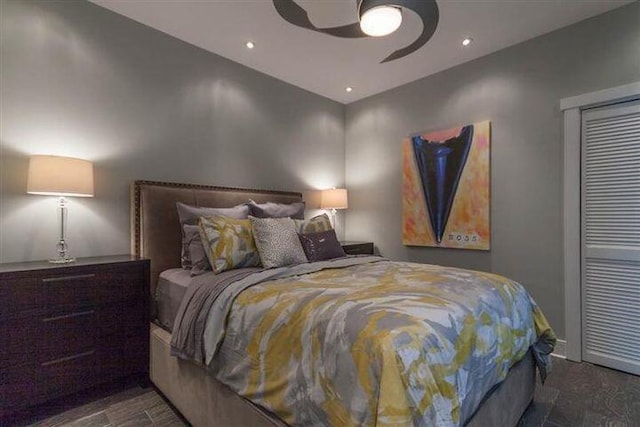 bedroom with dark hardwood / wood-style flooring and ceiling fan