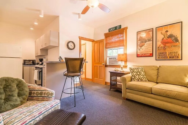 living room with ceiling fan and carpet floors