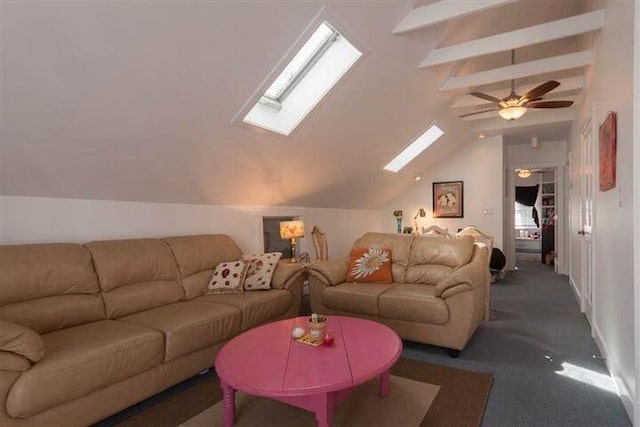 living room with dark carpet, lofted ceiling with skylight, and ceiling fan