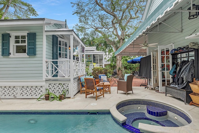 view of swimming pool featuring a patio, ceiling fan, and an in ground hot tub