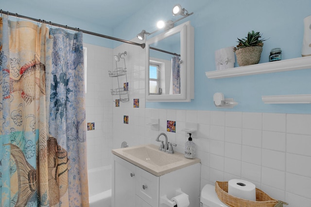 full bathroom featuring vanity, toilet, tile walls, and shower / bath combo