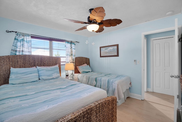 bedroom with ceiling fan and light wood-type flooring