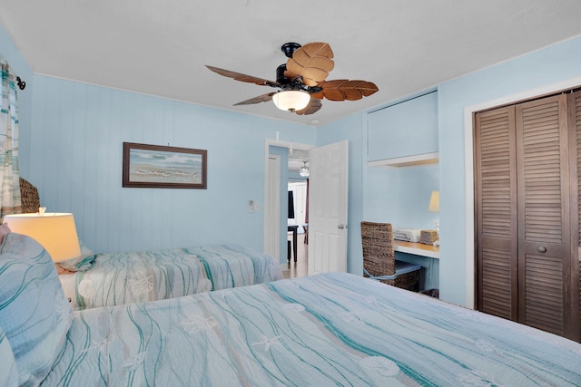 bedroom with ceiling fan and a closet