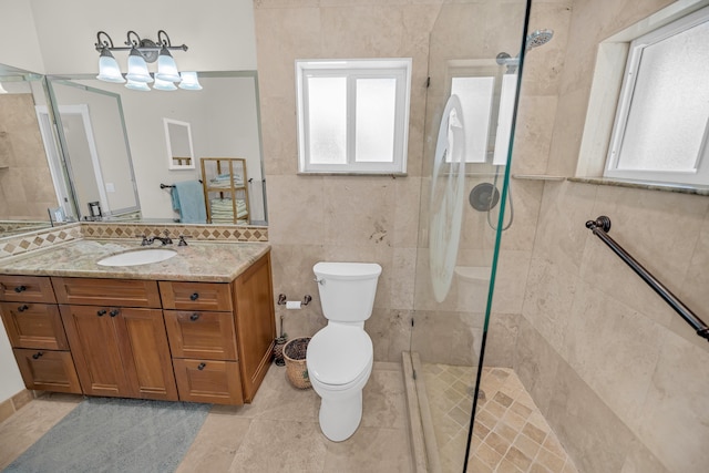 175 Galleon Rd, Islamorada, FL 33036 - bathroom featuring plenty of natural light, vanity, a walk in shower, tile walls, and tile patterned floors
