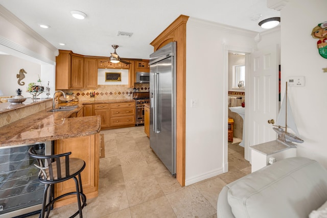 175 Galleon Rd, Islamorada, FL 33036 - kitchen featuring high end appliances, a peninsula, light stone countertops, backsplash, and crown molding