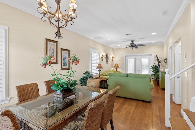 dining room with ornamental molding, recessed lighting, light wood-style flooring, and ceiling fan with notable chandelier