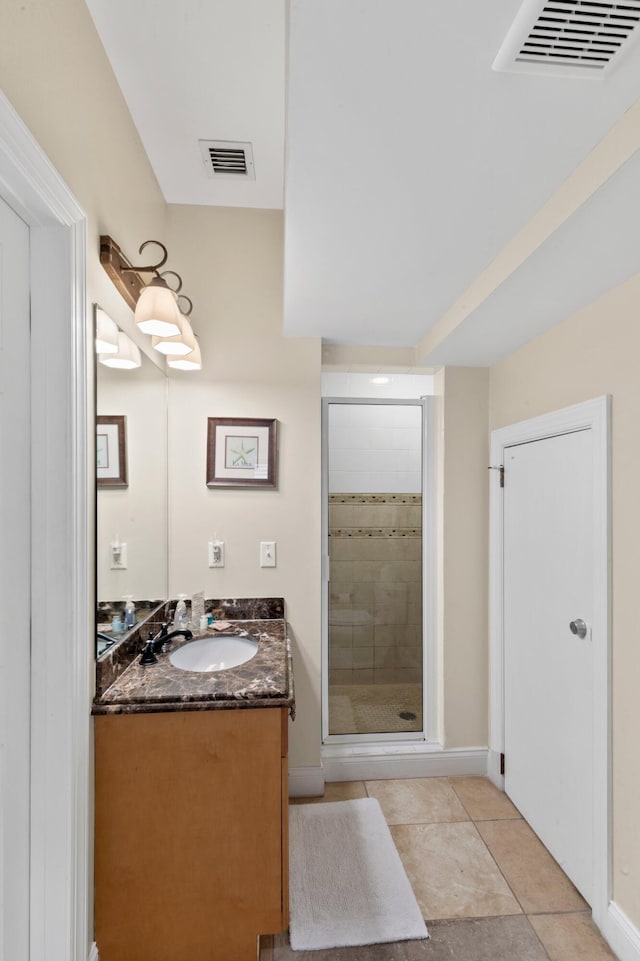 full bathroom with a stall shower, tile patterned flooring, visible vents, and vanity