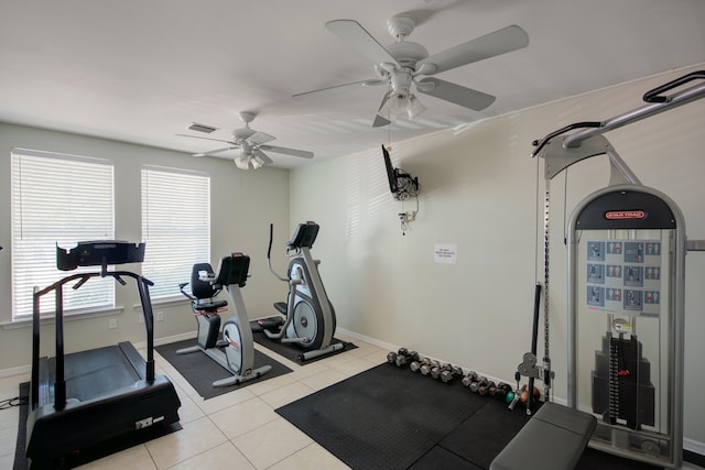 exercise area featuring light tile patterned floors, visible vents, and baseboards