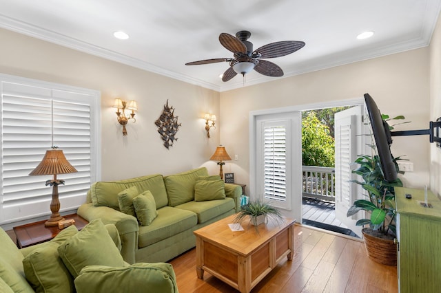 living room featuring wood-type flooring, ornamental molding, ceiling fan, and recessed lighting