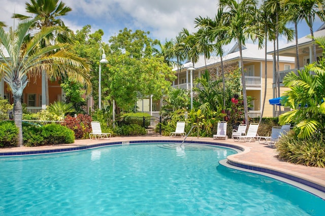 pool featuring a patio area and fence