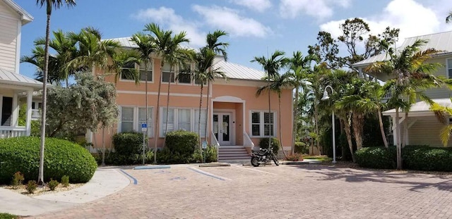 view of front facade with metal roof and stucco siding