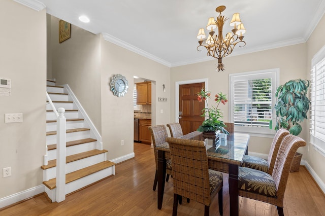 dining area featuring stairs, ornamental molding, baseboards, and light wood-style floors