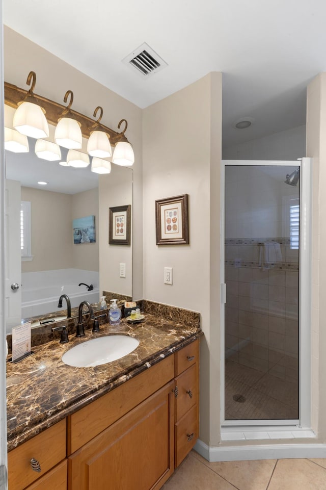 bathroom with visible vents, a shower stall, vanity, and tile patterned floors