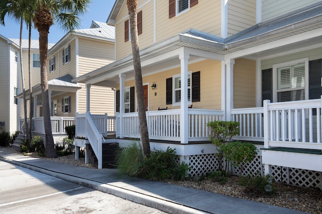 doorway to property with covered porch and metal roof