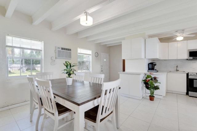 dining space featuring sink, beam ceiling, a wall unit AC, and light tile patterned flooring