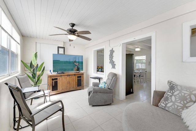 living room featuring light tile patterned flooring, ceiling fan, and wood ceiling