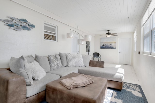 living room featuring light tile patterned floors, wooden ceiling, and ceiling fan