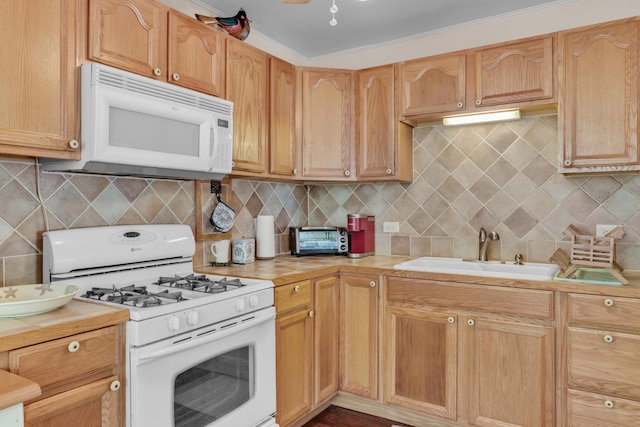 kitchen with white appliances, sink, and decorative backsplash