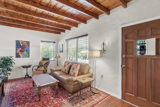 living room featuring beamed ceiling, hardwood / wood-style flooring, and wooden ceiling