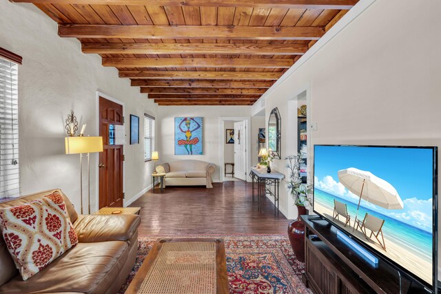 living room featuring beamed ceiling, dark wood-type flooring, and wood ceiling