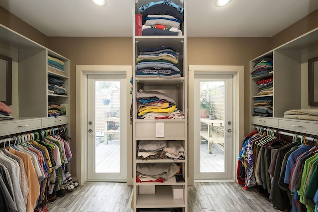 spacious closet featuring light wood-style flooring