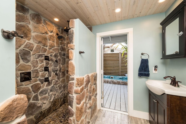 bathroom featuring recessed lighting, wood ceiling, vanity, wood finished floors, and a walk in shower