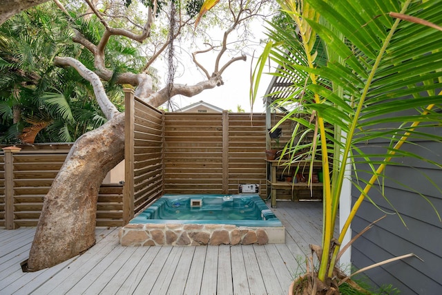 deck with an outdoor hot tub