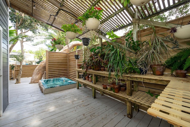 wooden terrace with hot tub deck surround and a pergola