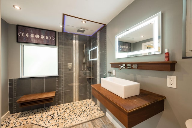 full bath featuring recessed lighting, a sink, a shower stall, and wood finished floors