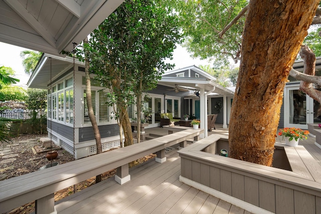 wooden terrace featuring ceiling fan