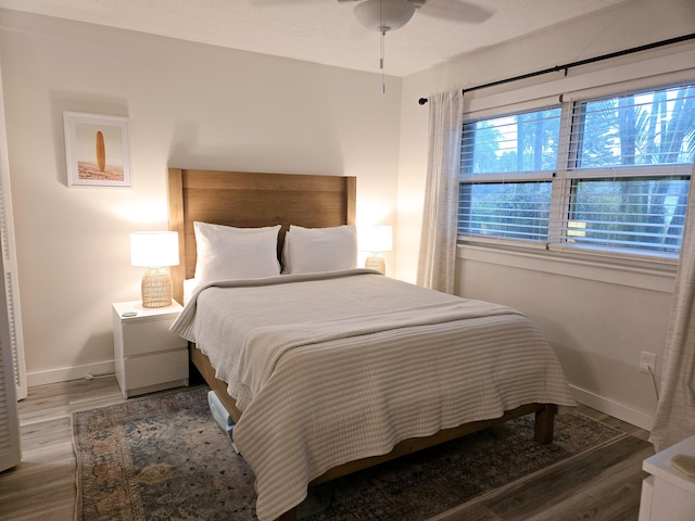 bedroom featuring baseboards and wood finished floors