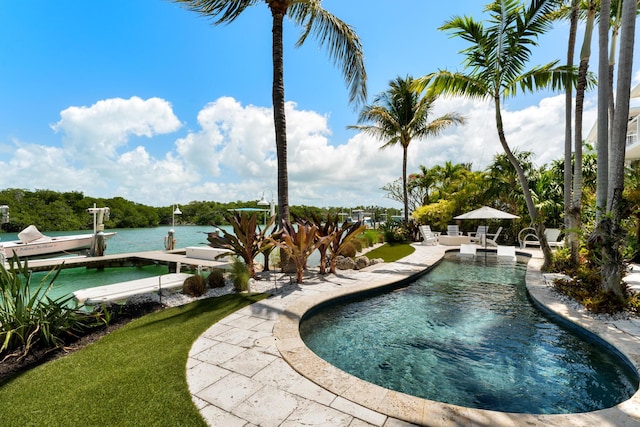 outdoor pool with a patio and a boat dock