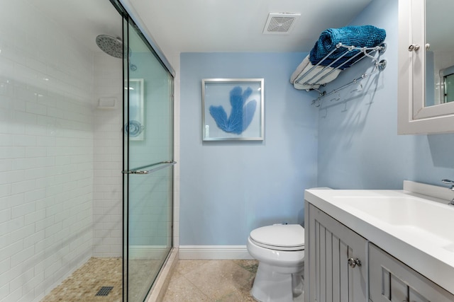 bathroom featuring a shower stall, baseboards, toilet, and vanity